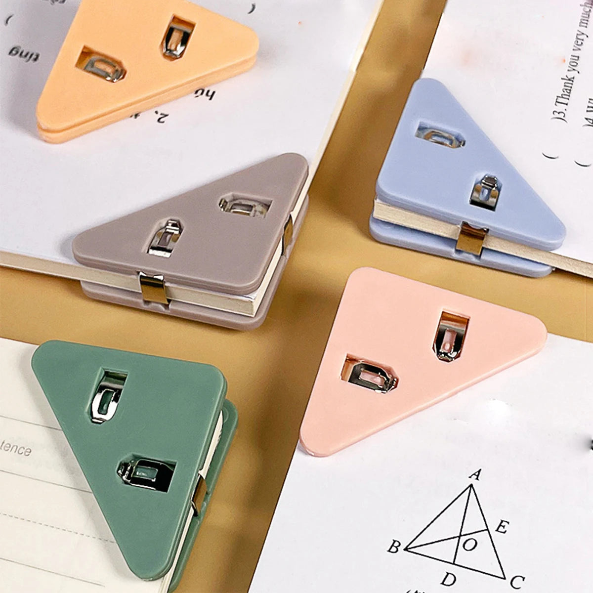 Three colored triangle folder clips are shown on a document, demonstrating different shades of pink, purple, and green.