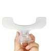 A hand holds a clear plastic book page clip designed to hold pages together.