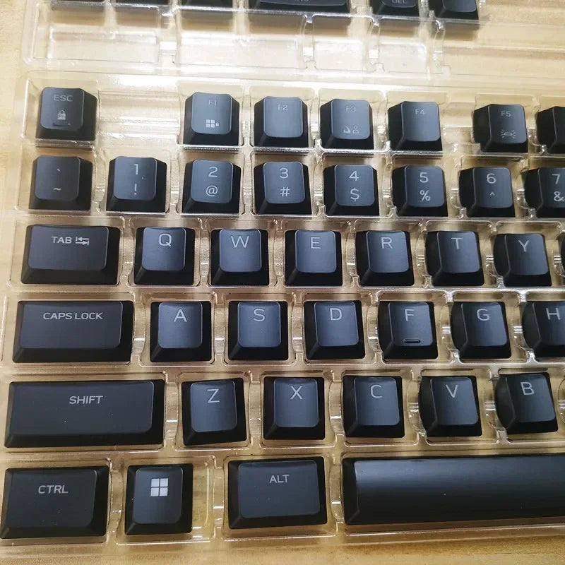 A close-up view of a black mechanical keyboard featuring various keycaps and switches.