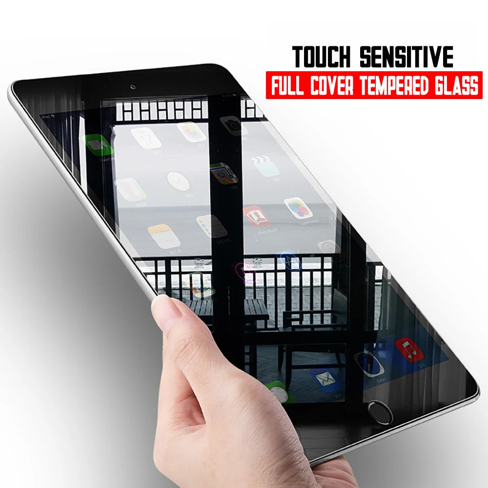 A hand holds an iPad with a full cover tempered glass screen protector applied, showing the protective film on the display.