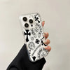 Clear acrylic phone case with black and white Chrome Hearts floral design featuring a horseshoe pattern.