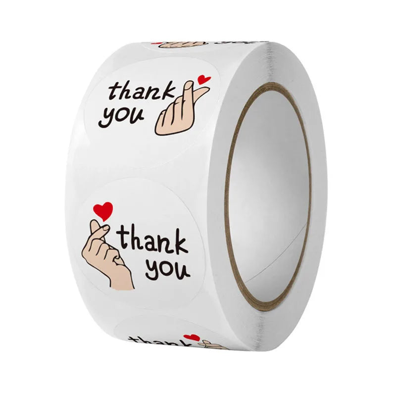 A roll of thank you stickers featuring a hand gesture and text on a white background.