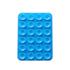 A blue silicone suction cup phone mount with multiple circular holes for mounting devices.