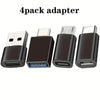 A set of four black and silver USB adapters, including USB-C to USB-A and Micro USB types.