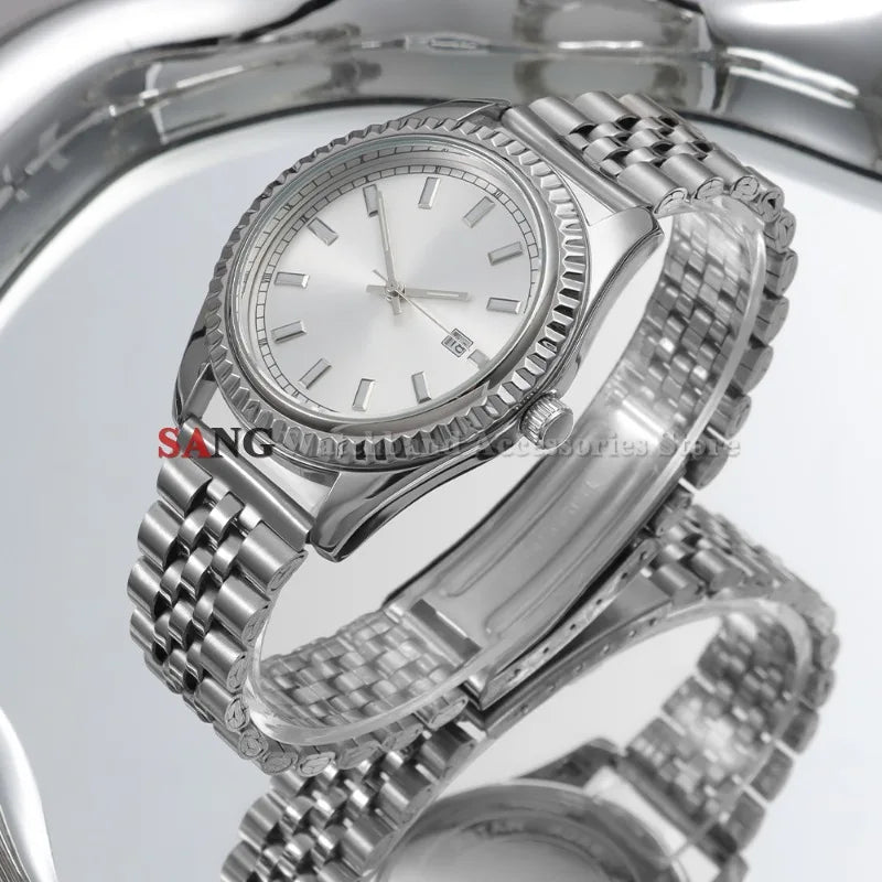 A close-up view of a polished stainless steel watch with a silver dial and bracelet on a reflective surface.