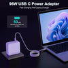 A purple 96W USB-C power adapter charging a MacBook Pro laptop.
