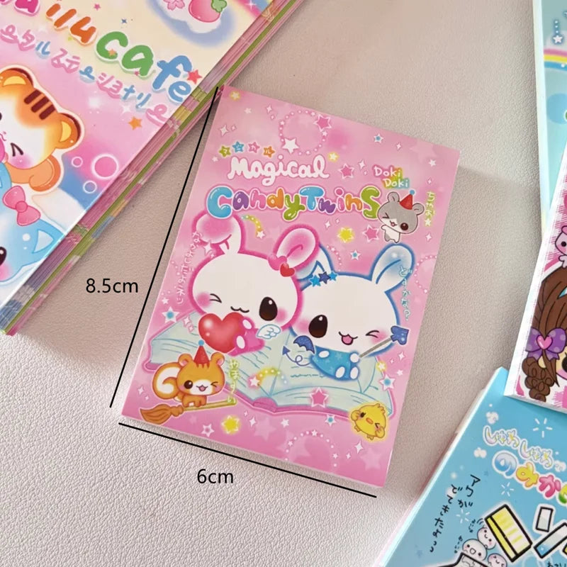 A close-up of a pink and white magical candy themed memo pad featuring cute animal characters.