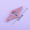 A pink resin thumb book stand with a cutout, shown from above.