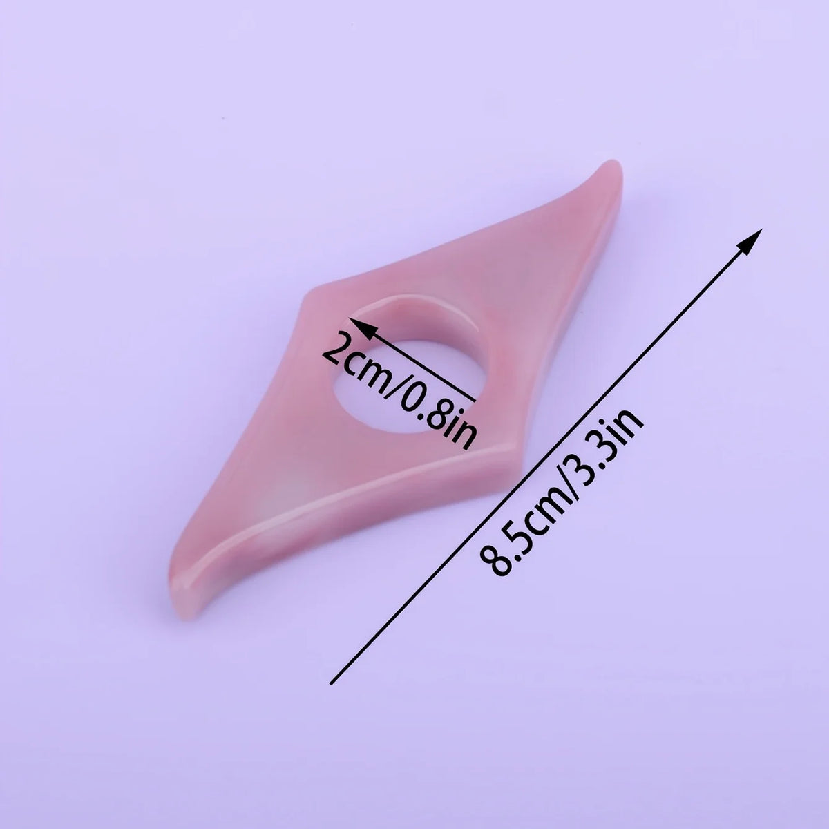 A pink resin thumb book stand with a cutout, shown from above.