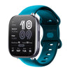 A teal silicone smartwatch with a black face and green strap displaying fitness metrics.