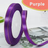 Purple gold edge satin ribbon rolled and unwound against a light background.