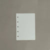 A white divider page with punched holes is shown against a gray background.