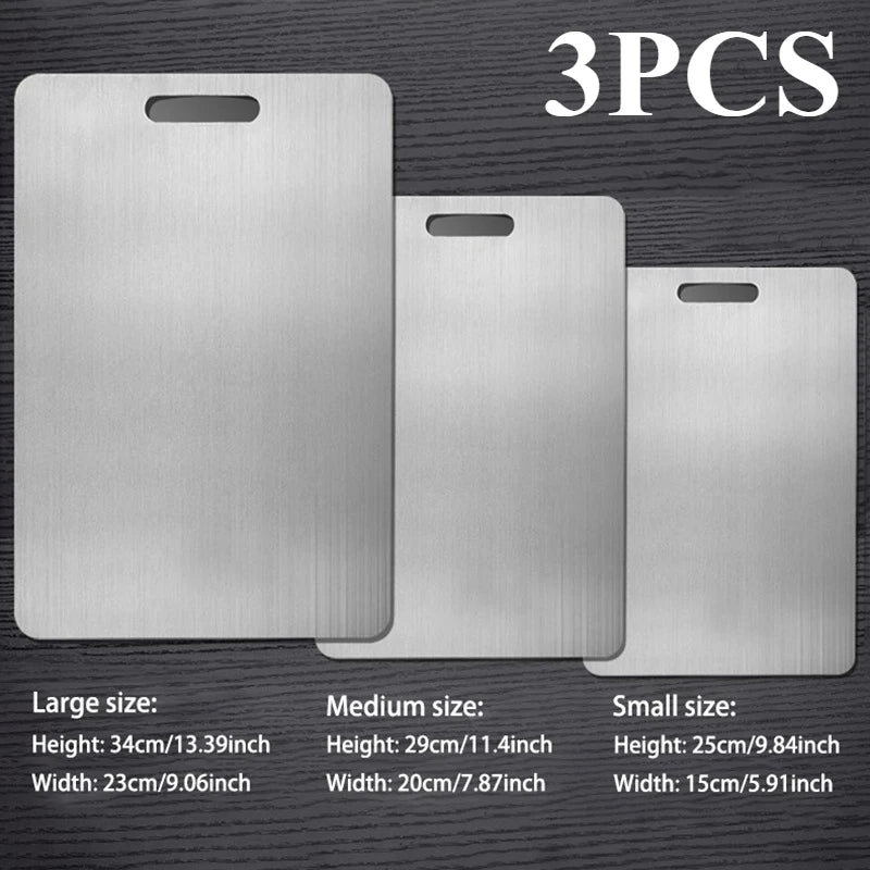 A set of three stainless steel double-sided cutting boards in large, medium, and small sizes.