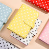 A collection of colorful reusable PU leather binders and wallets with various polka dot patterns.