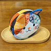 A patchwork cat face coin purse with a zipper featuring various floral and abstract patterns in orange, yellow, blue, and whi