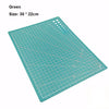 A green art cutting tool with a grid pattern and a circular hole for rotating.