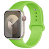 A silicone sport band in lime green color is shown around an Apple Watch.
