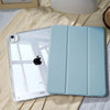A light blue universal protective case for an Apple iPad is shown resting on a beige fabric.