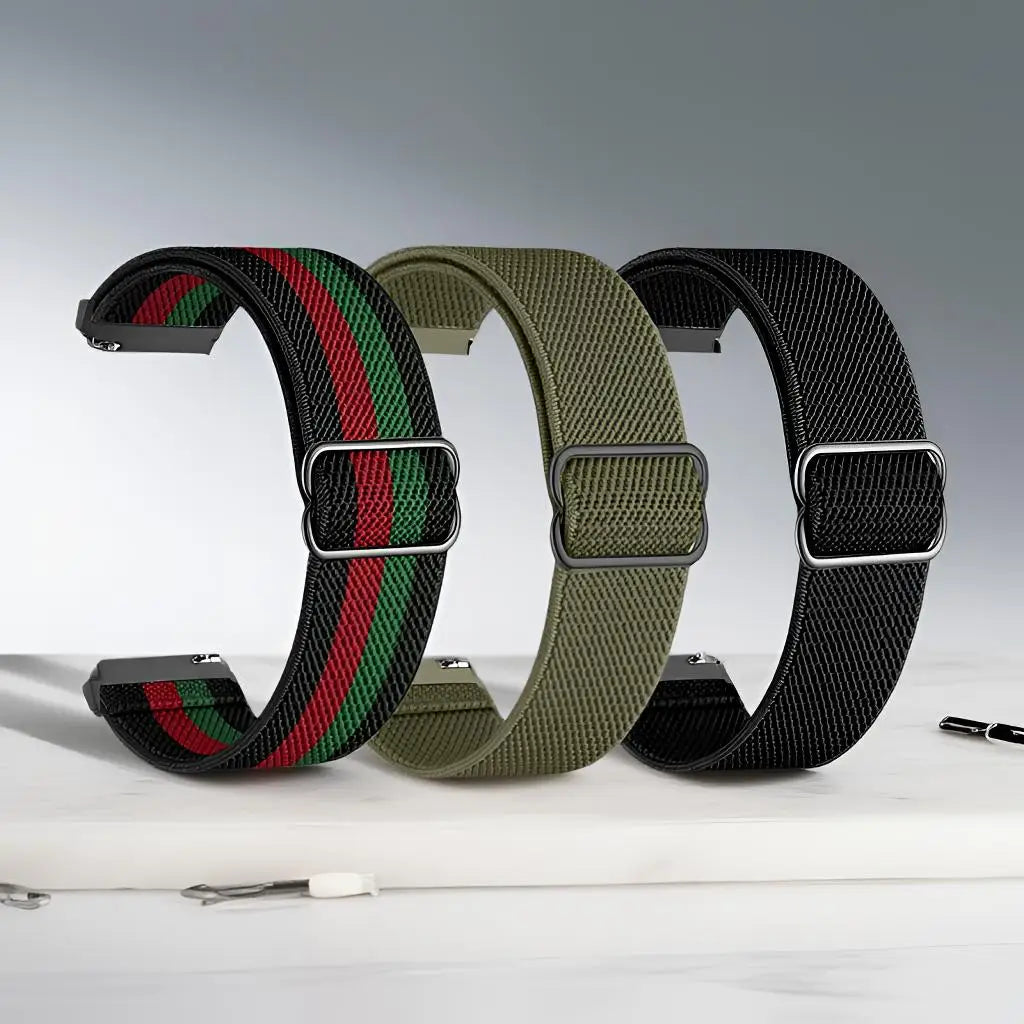 Three adjustable elastic sports bands in green, red, and black stacked on a white surface.