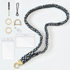 A black and blue patterned stretchy breakaway ID badge lanyard with a gold-colored clip and retractable reel.