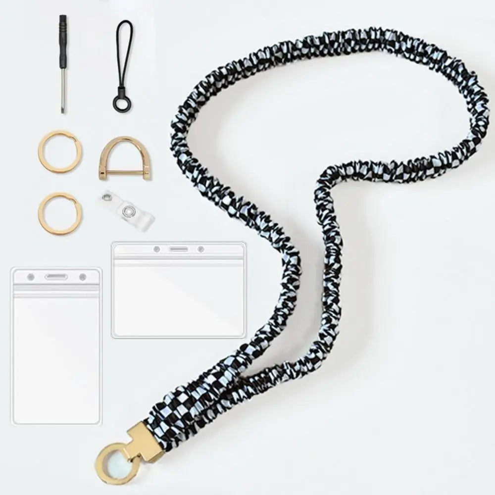 A black and blue patterned stretchy breakaway ID badge lanyard with a gold-colored clip and retractable reel.