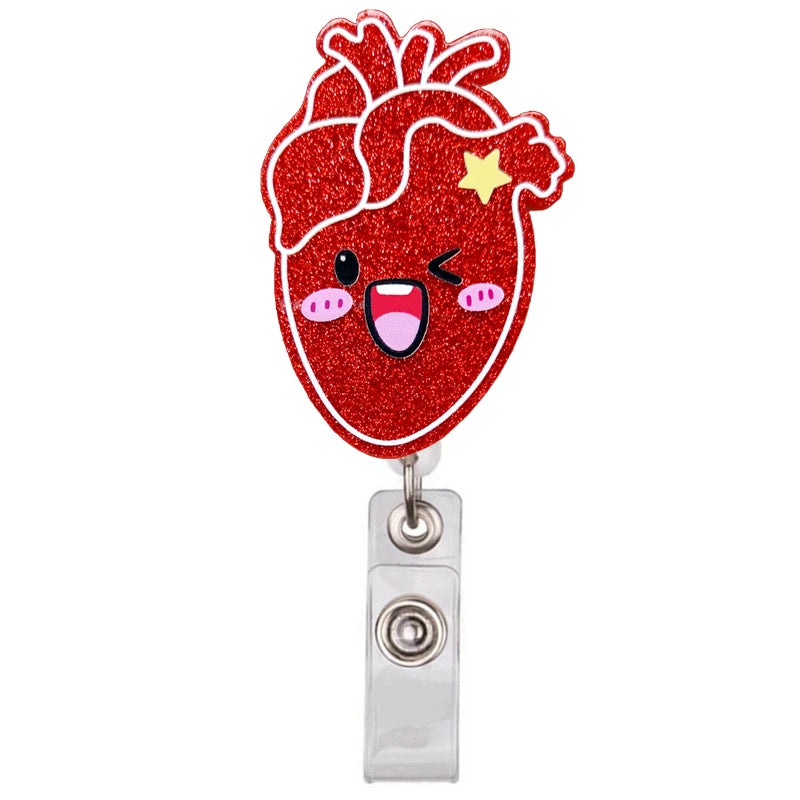 A red glitter heart shaped badge reel holder with a smiling face and a yellow star detail.
