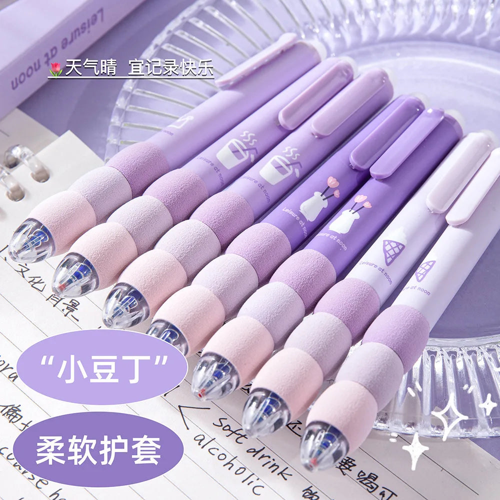 A set of purple and pink erasable gel pens with soft grips displayed on a white surface.