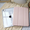 A pink universal protective case for an Apple iPad is shown resting on a light fabric.