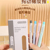 A set of six retractable pencil erasers in various pastel colors, packaged in a box, being held by a hand.