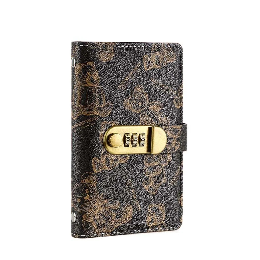 A black leather wallet featuring a gold-toned lock and intricate bear pattern.