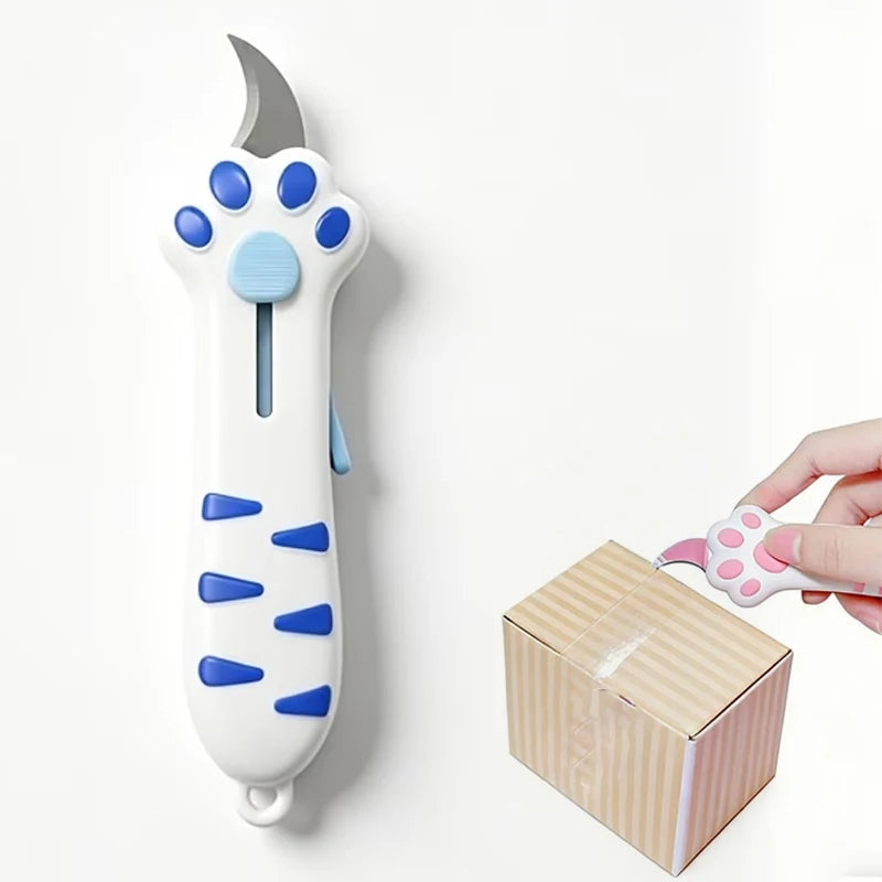 A white retractable utility knife shaped like a cat paw with blue accents, shown next to its packaging box.