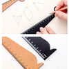 A wooden drawing ruler is shown with various geometric shapes and a pencil, demonstrating its use for drawing.