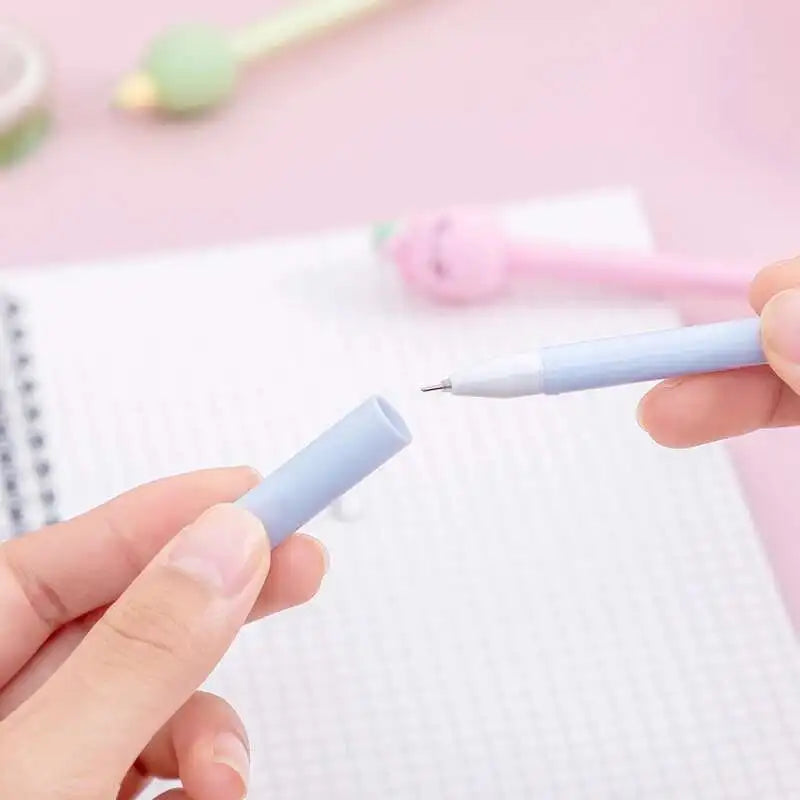 A hand holds a light blue gel pen writing on a white lined paper.