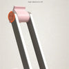A pink and silver adjustable tablet and phone stand with a smooth surface.