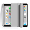 A silver tablet with a clear protective case showing various app icons on the screen.