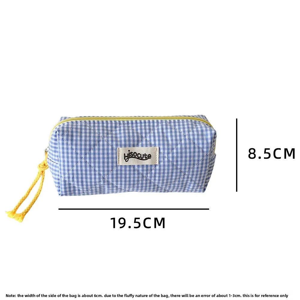 A light blue checkered pencil case with yellow drawstring on the side.