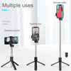 A portable extendable Bluetooth selfie stick with a fill light mounted on a tripod stand.