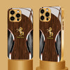 A golden horse wood grain tempered glass phone case for an iPhone displayed on a stand.