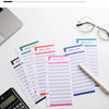 A set of A6 budget planner sheets, including budget sheets and expense sheets, are displayed next to a calculator and eyeglas