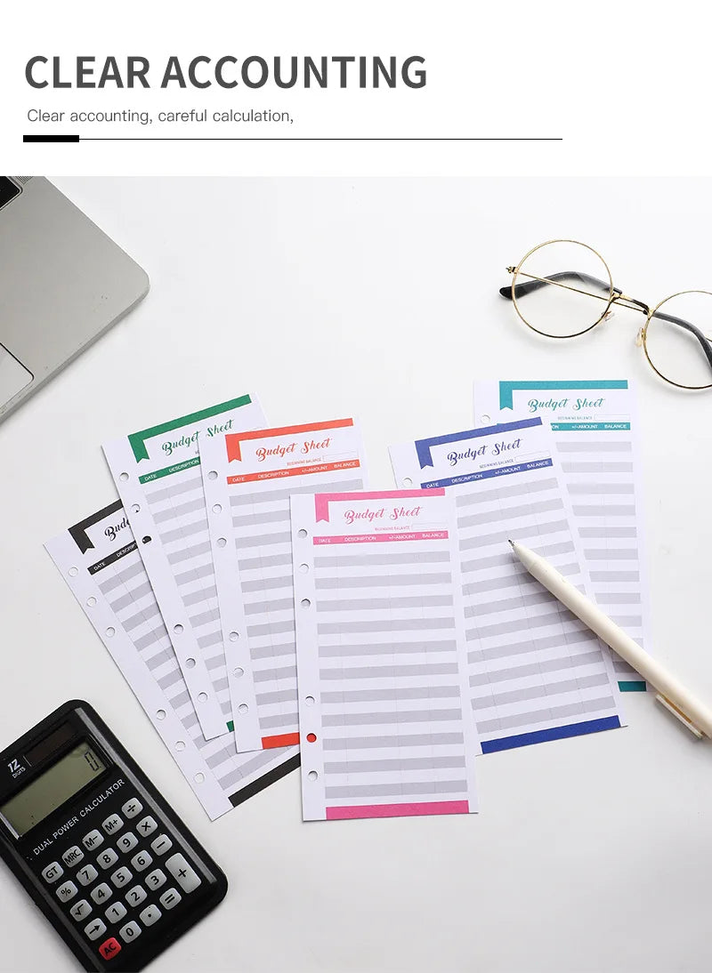 A set of A6 budget planner sheets, including budget sheets and expense sheets, are displayed next to a calculator and eyeglas