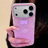 A hand holds a pink polka dot shockproof phone case with a purple accent on a smartphone.