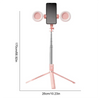 A pink multifunctional selfie stick tripod with a smartphone mount and two circular lights.