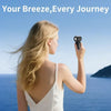 A blonde woman holds a black mini fan, titled Your Breeze, Every Journey, against a blue sea background.