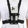 A black adjustable mount is attached to a white t-shirt, designed to hold a smartphone or action camera.