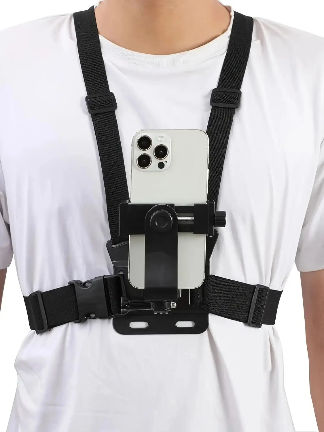 A black adjustable mount is attached to a white t-shirt, designed to hold a smartphone or action camera.