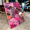 A pink tablet case featuring a vibrant graphic design with text and floral elements is held in a hand.