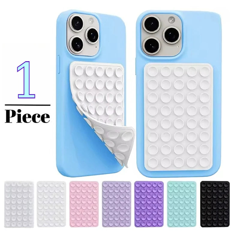 A set of double-sided silicone phone grips in various colors and patterns for mounting smartphones.