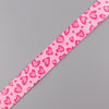 Pink fabric lanyard with a repeating pattern of small pink hearts