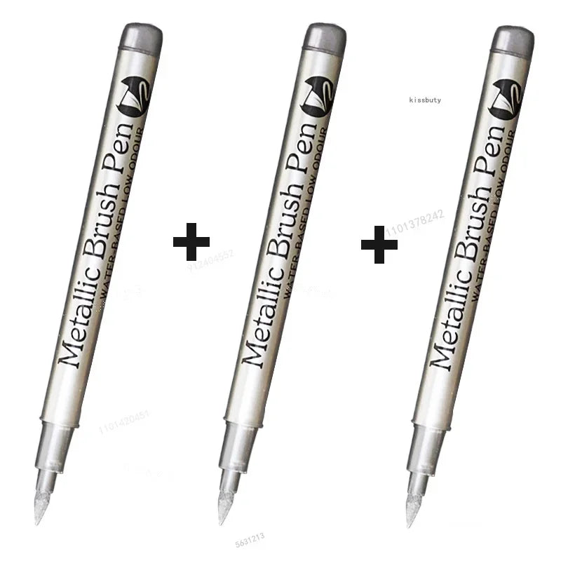 Three metallic brush pen markers shown vertically with black text and a silver body.