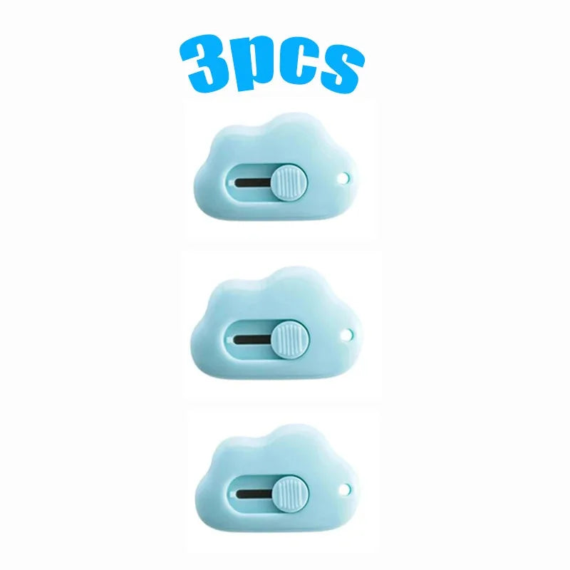 Three light blue utility knives packaged together.